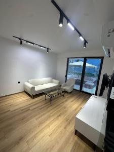 a living room with a couch and a table at Toidze's apartment1 in Kobuleti +15 photos