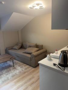 a living room with a couch and a table at Premium Rooms in Struga