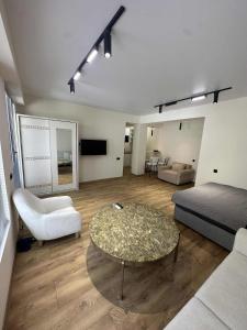 a living room with a bed and a coffee table at Toidze's apartment1 in Kobuleti
