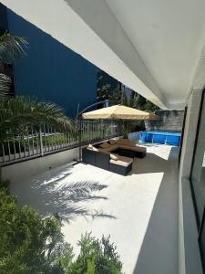 a patio with an umbrella and a swimming pool at Toidze's apartment1 in Kobuleti