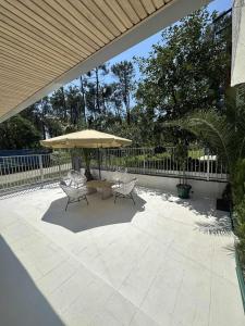a patio with two chairs and an umbrella at Toidze's apartment1 in Kobuleti