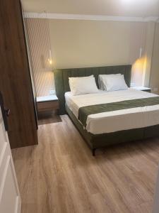 a bedroom with a large bed in a room at Premium Rooms in Struga