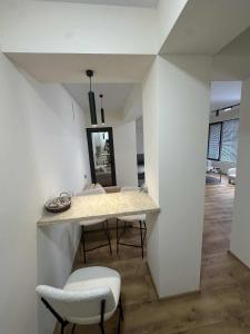 a kitchen with white walls and a table and chairs at Toidze's apartment1 in Kobuleti