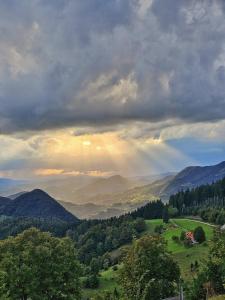 a view of a mountain valley with a rainbow at Apartment Boris Sveta Planina in Knezdol