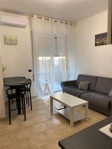 a living room with a couch and a table at Faraboni Apartments in Novara