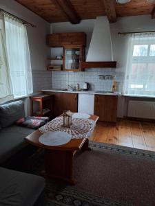 a living room with a table and a kitchen at Agroturystyka Folwark in Leszno +27 photos