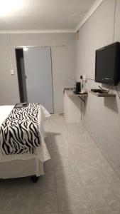 a room with a bed and a television in it at JJM Accommodation in Keetmanshoop