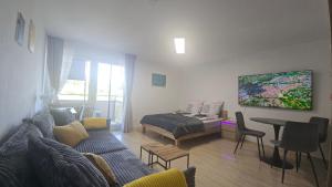 a living room with a couch and a bed at InnJoy! in Friedrichshafen