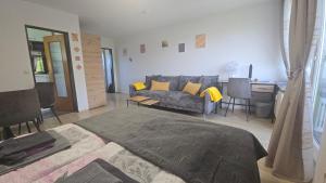 a living room with a bed and a couch at InnJoy! in Friedrichshafen