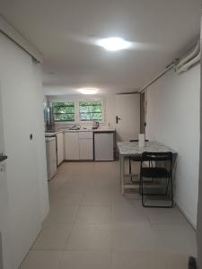 a large white kitchen with a table and a counter at Maison du Bonheur Chelles in Chelles