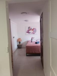 a bedroom with a bed with a pink bedspread at Maison du Bonheur Chelles in Chelles