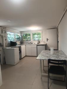 a kitchen with white appliances and a table in it at Maison du Bonheur Chelles in Chelles
