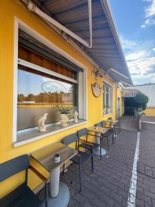 a row of tables and chairs on the side of a building at Albergo Nuova Aurora - FREE PARKING & BREAKFAST in Marghera