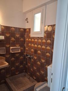 a bathroom with a shower and a toilet and a window at Balcony to Aegeon 4 in Apollon +24 photos