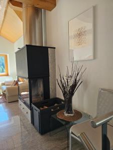 a living room with a fireplace and a table and chairs at Cà ai Camòss, DUPLEX deluxe - centro paese in San Bernardino