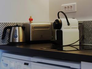 a kitchen counter with a toaster at Une Heure Bleue in Manosque
