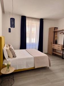 a bedroom with a large bed and a window at Frida Luxury B&B in Vietri sul Mare