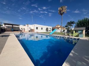 a swimming pool with a slide in front of a house at San Calixto 8 in Sanlúcar de Barrameda