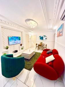 a living room with a red couch and a table at Astra Home in Pointe-Noire