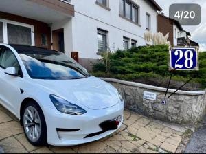 a white car parked in front of a house at Apartment Ferienwohnung in Sulzbach