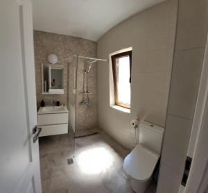 a bathroom with a toilet and a sink and a window at AL MARE in Constanţa +20 photos