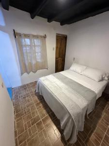 a bedroom with a bed and a window at HIDDEN HOSTAL MONTANITa in Montañita +15 photos