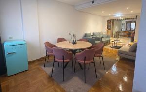 a living room with a table and chairs and a couch at Hotel El Molinón in Cangas del Narcea