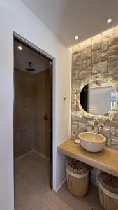 a bathroom with a sink and a mirror at Pyrgianos Suites - Private Plunge Pool in Naxos Chora +6 photos