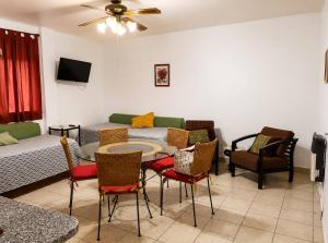 a living room with a couch and a table and chairs at Peatonal y San Martin in Mendoza