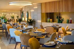 a dining room with tables and chairs in a restaurant at Hotel Nacional in Rio de Janeiro