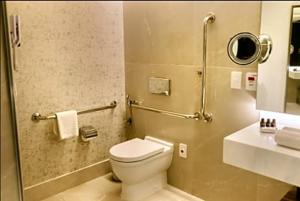 a bathroom with a white toilet and a sink at Hotel Nacional in Rio de Janeiro +3 photos