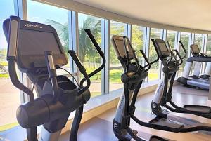 three exercise bikes in a gym next to a window at Hotel Nacional in Rio de Janeiro