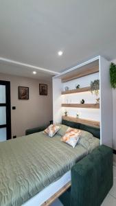a bedroom with a bed with two pillows on it at La Parenthèse in Sangatte
