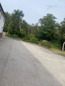 an empty road with trees on the side of a house at Wirral Park Hotel in Greasby