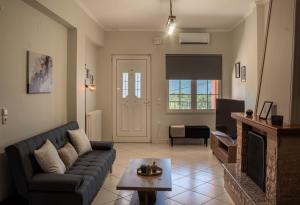a living room with a couch and a fireplace at Casa Panorama in Igoumenitsa