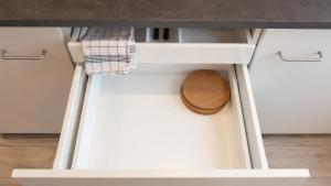 a drawer in a kitchen with a hat in it at Subway Apartment in Koblenz