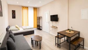 a living room with a couch and a table at Subway Apartment in Koblenz