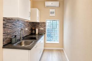 a kitchen with a sink and a window at Subway Apartment in Koblenz +1 photo