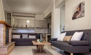 a living room with a couch and a fireplace at Casa Panorama in Igoumenitsa