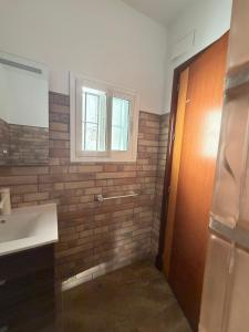 a bathroom with a sink and a window at San Calixto 8 in Sanlúcar de Barrameda +36 photos