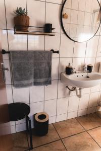 a bathroom with a sink and a mirror and a towel at Garingboom Guest Farm in Groot-Suurfontein