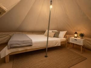 a bedroom with a bed in a tent at VaMood in Vama Veche