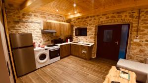 a kitchen with a refrigerator and a washing machine at Casa Stratigos in Corfu