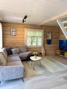 a living room with a couch and a table at Orjaku Sadamavaade in Orjaku