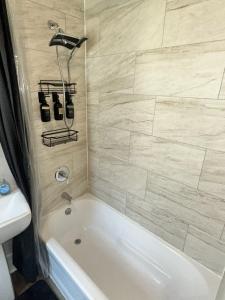 a bathroom with a white bath tub and a sink at Tranquil studio oasis in Minneapolis +38 photos