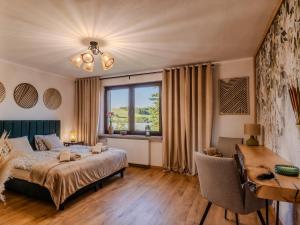 a bedroom with a bed and a desk and a window at OSNOWA Racławice in Racławice +103 photos