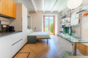 a kitchen with a bed in a room at Lakeside Garden Studio in Laglio +27 photos