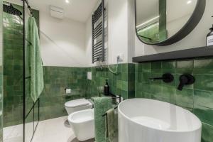 a bathroom with a white sink and a mirror at Lakeside Garden Studio in Laglio