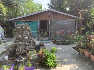a garden with plants in front of a building at Mangifera Cabin in Kanchanrup in Kanchanpur