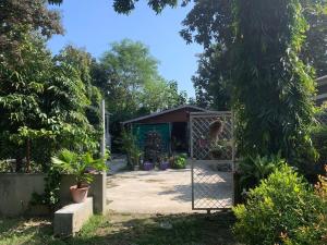 a garden with a gate and a shed at Mangifera Cabin in Kanchanrup in Kanchanpur